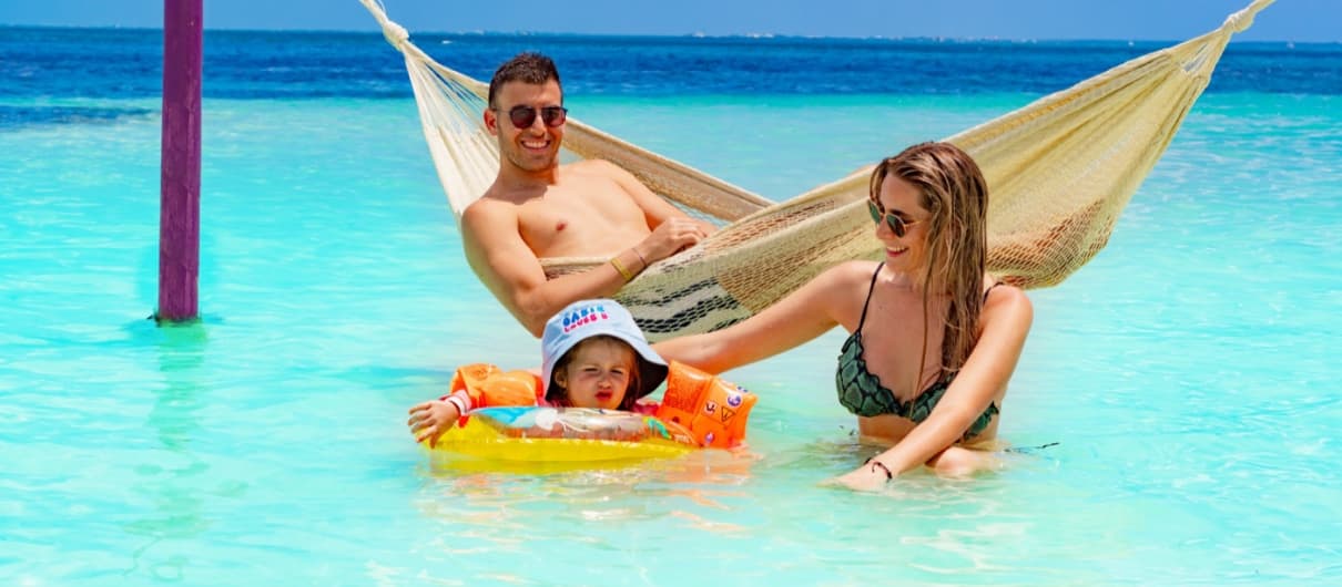 Family enjoying the sea on a hammock in Cancun